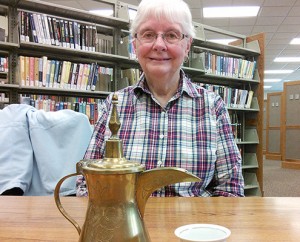Phyllis Vander Werff with an Arab-style coffee pot and cup from Kuwait; photo by Anna Bartlett